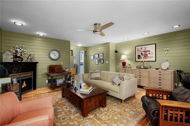 306 Pig Trl, Cherry Log, GA 30522 - living room featuring a large fireplace, ceiling fan, wood walls, and wood finished floors