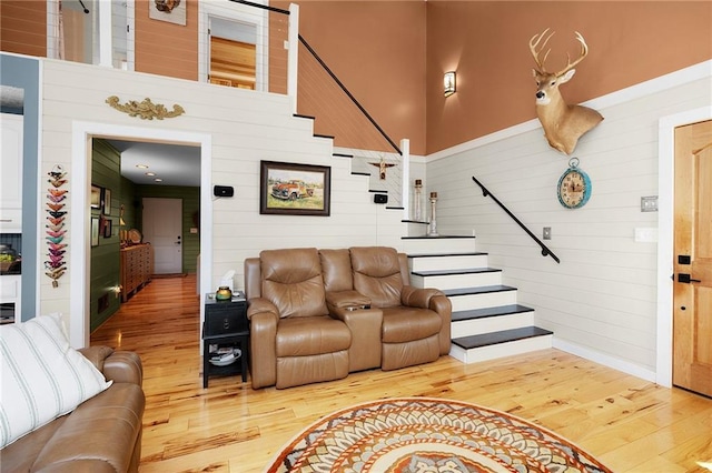 306 Pig Trl, Cherry Log, GA 30522 - living area featuring baseboards, wood finished floors, wooden walls, and stairway