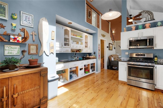 306 Pig Trl, Cherry Log, GA 30522 - kitchen with white cabinetry, a towering ceiling, ceiling fan, and stainless steel appliances