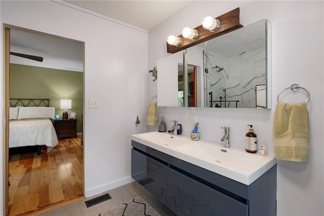 306 Pig Trl, Cherry Log, GA 30522 - ensuite bathroom with visible vents, wood finished floors, baseboards, a sink, and ensuite bath
