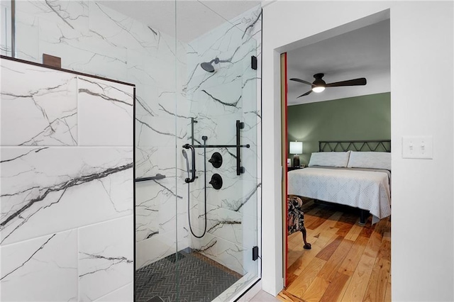 306 Pig Trl, Cherry Log, GA 30522 - bathroom with a marble finish shower, a ceiling fan, hardwood / wood-style floors, and connected bathroom