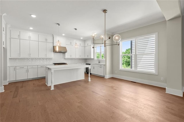 1417 Coretta Scott Bnd, Atlanta, GA 30318 - kitchen featuring under cabinet range hood, baseboards, backsplash, white cabinetry, and recessed lighting