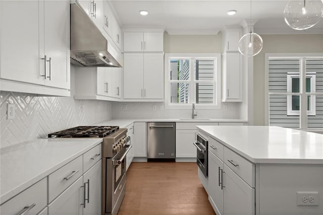 1417 Coretta Scott Bnd, Atlanta, GA 30318 - kitchen with under cabinet range hood, appliances with stainless steel finishes, a sink, decorative backsplash, and white cabinetry