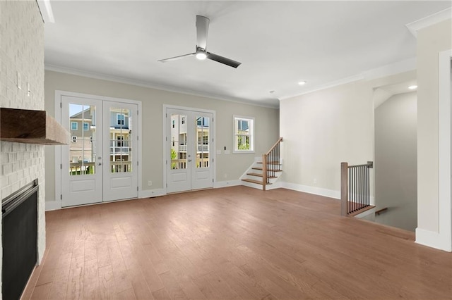1417 Coretta Scott Bnd, Atlanta, GA 30318 - unfurnished living room featuring a ceiling fan, wood finished floors, ornamental molding, french doors, and baseboards
