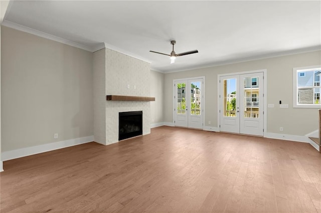 1417 Coretta Scott Bnd, Atlanta, GA 30318 - unfurnished living room with ceiling fan, light wood-style floors, a large fireplace, ornamental molding, and plenty of natural light