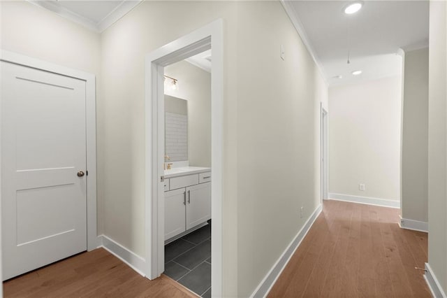 1417 Coretta Scott Bnd, Atlanta, GA 30318 - hall with ornamental molding, wood finished floors, baseboards, recessed lighting, and attic access