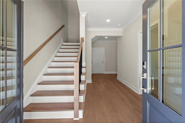 1417 Coretta Scott Bnd, Atlanta, GA 30318 - foyer with crown molding, stairs, wood finished floors, baseboards, and recessed lighting