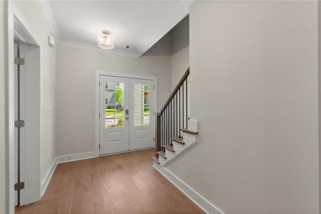 1417 Coretta Scott Bnd, Atlanta, GA 30318 - entrance foyer with baseboards, french doors, wood finished floors, stairs, and ornamental molding