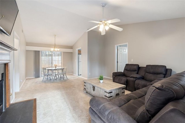 carpeted living room featuring ceiling fan with notable chandelier and lofted ceiling