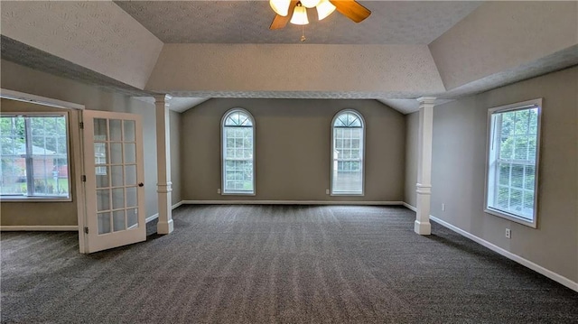 4373 Abram Dr, Conley, GA 30288 - carpeted spare room with decorative columns, plenty of natural light, ceiling fan, lofted ceiling, and baseboards