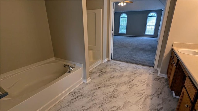 4373 Abram Dr, Conley, GA 30288 - bathroom featuring baseboards, vanity, marble finish flooring, and a garden tub