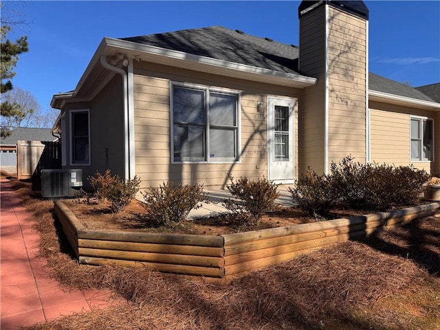 view of side of property featuring central AC