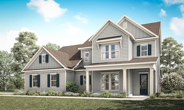 craftsman house featuring a shingled roof, board and batten siding, and a front lawn