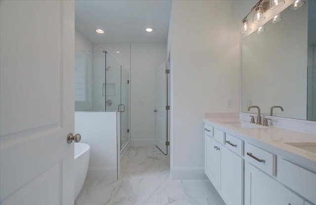 bathroom featuring a stall shower, baseboards, marble finish floor, a freestanding bath, and a sink