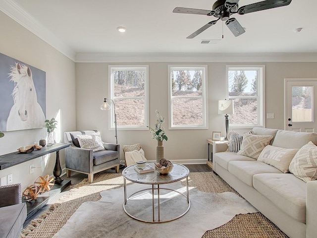 living room with ornamental molding, wood finished floors, and a healthy amount of sunlight