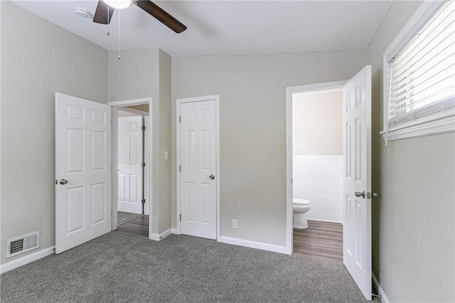 unfurnished bedroom featuring ceiling fan, vaulted ceiling, and carpet flooring