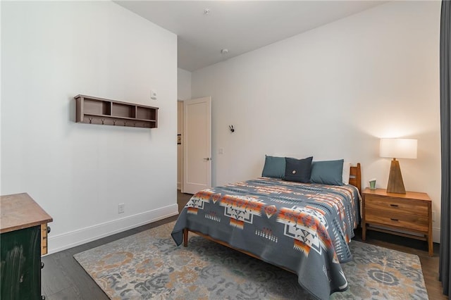 bedroom featuring dark wood-style floors and baseboards