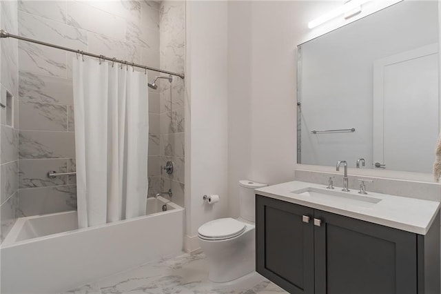 full bath with marble finish floor, shower / bath combo with shower curtain, vanity, and toilet