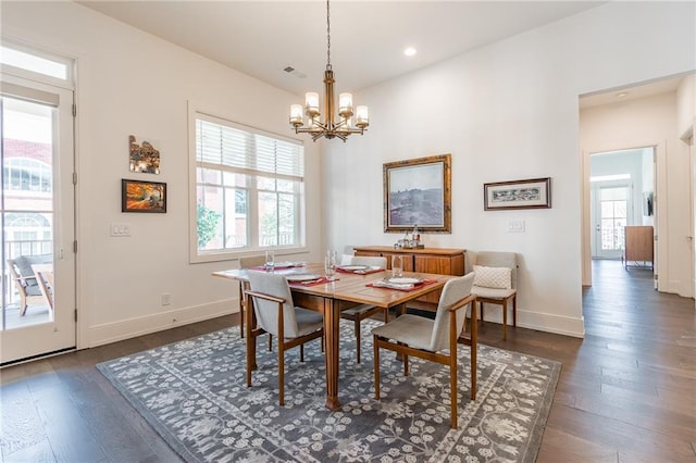dining room with baseboards, dark wood-style flooring, an inviting chandelier, and recessed lighting