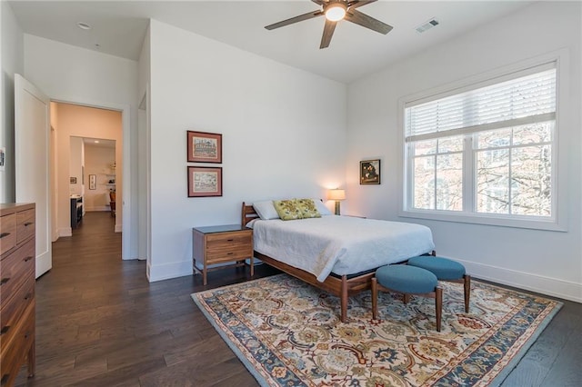 bedroom with dark wood-type flooring, baseboards, visible vents, and a ceiling fan