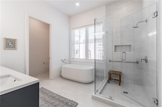 full bath featuring a shower stall, baseboards, tile patterned floors, vanity, and a freestanding bath