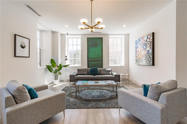 living room featuring a chandelier, wood finished floors, baseboards, visible vents, and recessed lighting