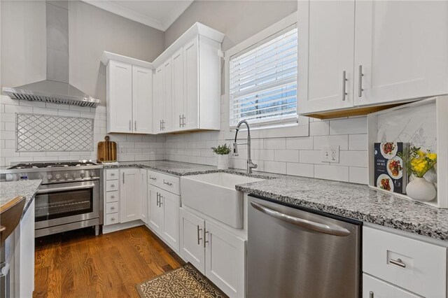 459 James P Brawley Dr NW, Atlanta, GA 30318 - kitchen featuring crown molding, a sink, stainless steel appliances, wall chimney range hood, and dark wood-type flooring