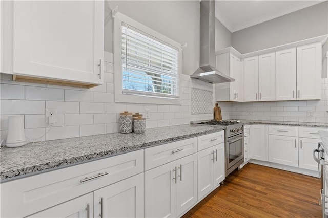 459 James P Brawley Dr NW, Atlanta, GA 30318 - kitchen with white cabinets, wood finished floors, wall chimney exhaust hood, stainless steel range, and backsplash