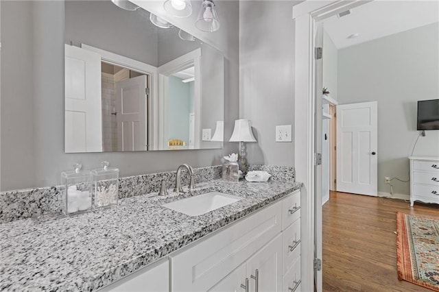 459 James P Brawley Dr NW, Atlanta, GA 30318 - bathroom featuring vanity, baseboards, and wood finished floors