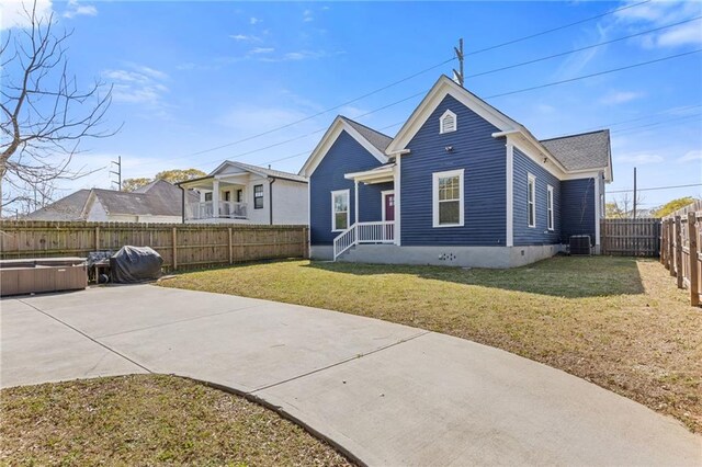 459 James P Brawley Dr NW, Atlanta, GA 30318 - view of front of house featuring a patio, central AC unit, a fenced backyard, and a front yard