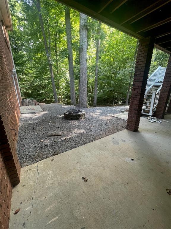 2166 Lake Ridge Ter, Lawrenceville, GA 30043 - view of patio / terrace featuring an outdoor fire pit and stairs