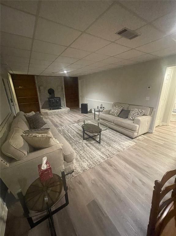 2166 Lake Ridge Ter, Lawrenceville, GA 30043 - living area with a paneled ceiling, wood finished floors, and a wood stove