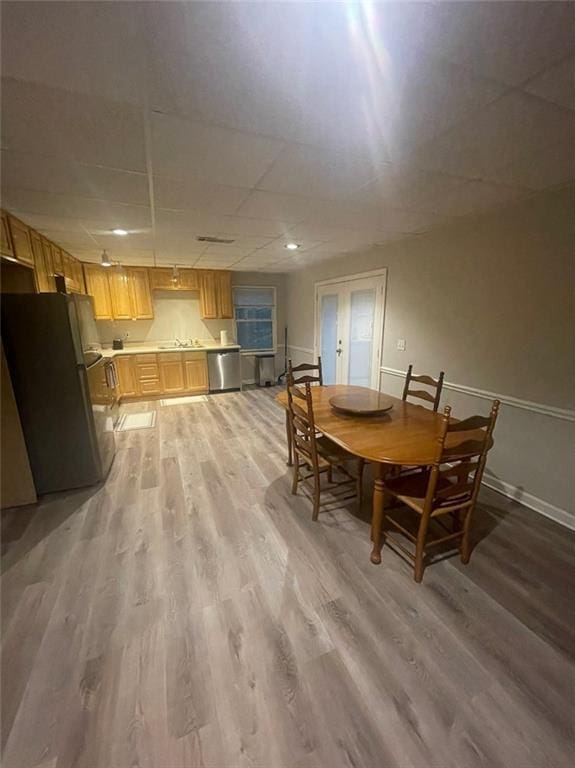 2166 Lake Ridge Ter, Lawrenceville, GA 30043 - dining space with light wood finished floors, baseboards, and a paneled ceiling