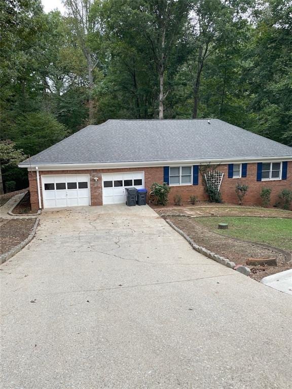 2166 Lake Ridge Ter, Lawrenceville, GA 30043 - single story home with brick siding, driveway, a shingled roof, and an attached garage