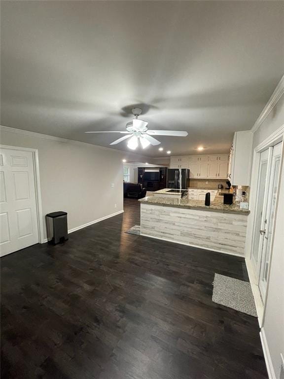 2166 Lake Ridge Ter, Lawrenceville, GA 30043 - unfurnished living room with baseboards, a ceiling fan, dark wood-style flooring, crown molding, and recessed lighting