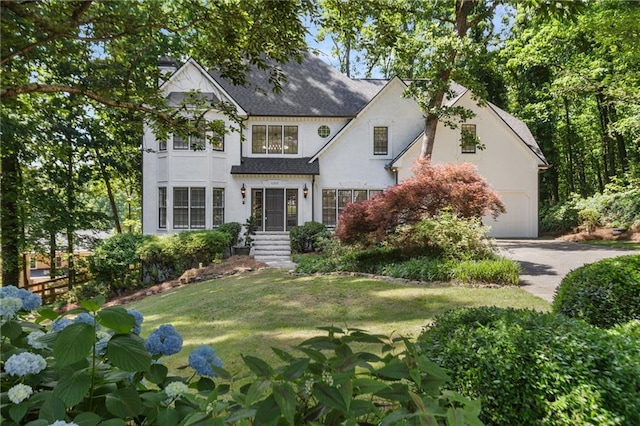 view of front of house with a garage and a front yard