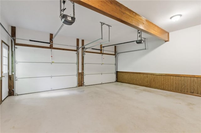 garage with wooden walls and a garage door opener