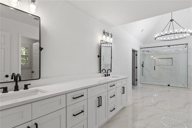 bathroom featuring vanity, an inviting chandelier, a shower with shower door, and vaulted ceiling