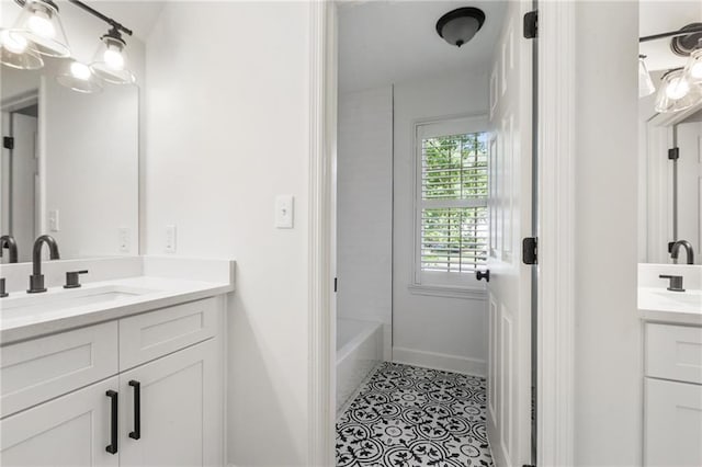 bathroom with tile patterned flooring, vanity, and washtub / shower combination