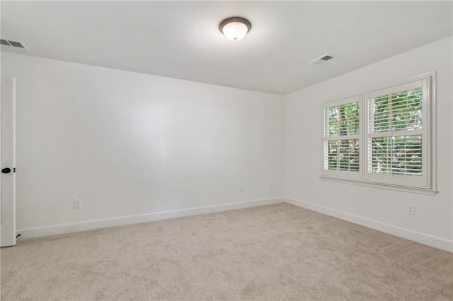 spare room with light colored carpet