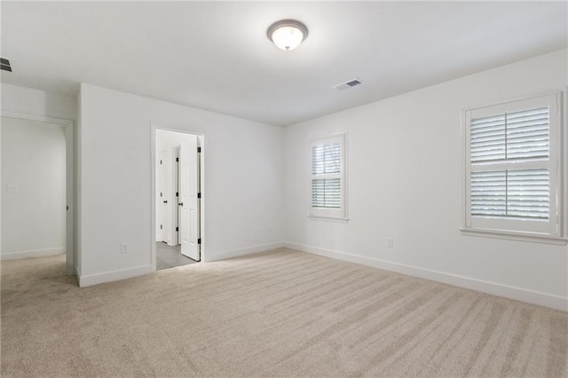 empty room with light colored carpet