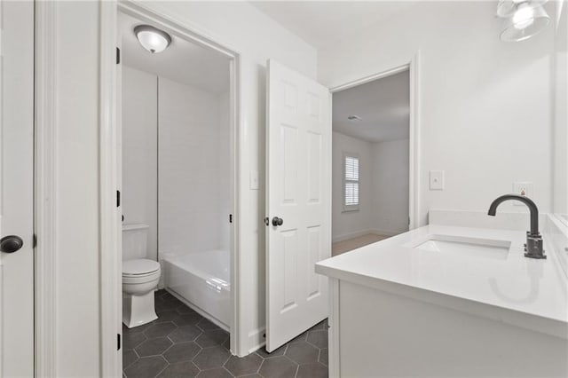 full bathroom featuring toilet, vanity, tile patterned floors, and  shower combination