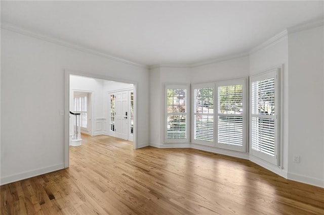 empty room featuring light hardwood / wood-style floors and ornamental molding