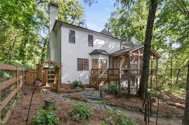 rear view of house featuring a sunroom