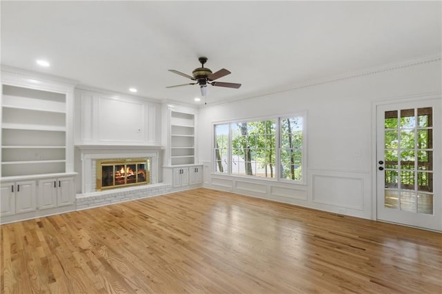 unfurnished living room featuring light hardwood / wood-style floors, built in features, and ceiling fan