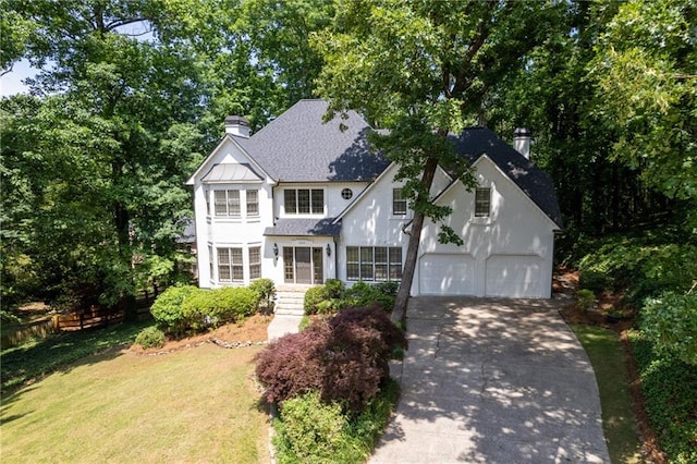 view of front of house with a garage and a front lawn