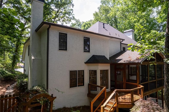 back of house featuring a sunroom