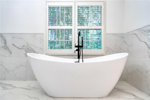 bathroom featuring tile walls and a bathing tub