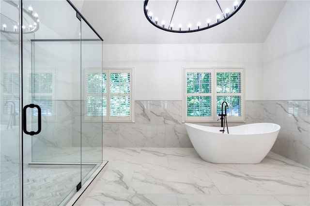 bathroom with a healthy amount of sunlight, tile walls, and shower with separate bathtub