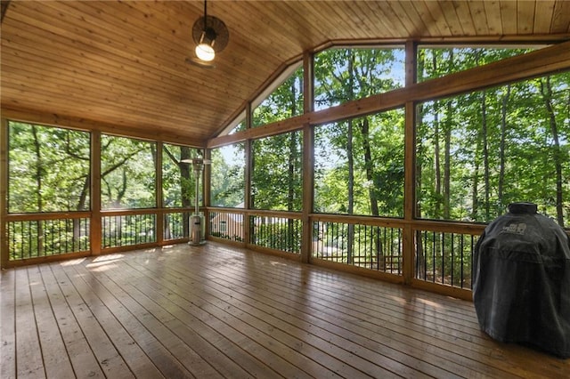 unfurnished sunroom featuring wood ceiling and lofted ceiling